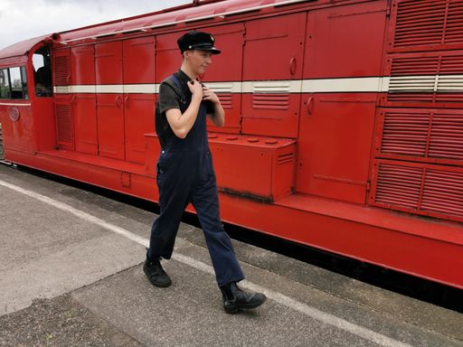 View of train driver's secondman walking along diesel locomotive at Glenbrook Vintage Railway