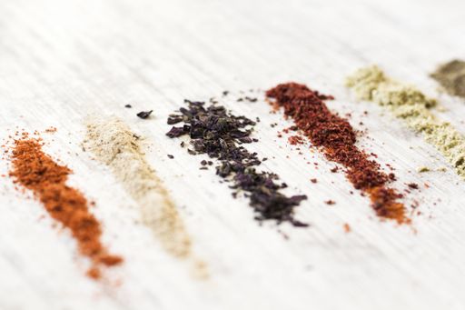 A flat lay of the variety of spices on the white table