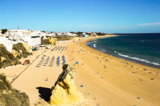 A high angle view of the Albufeira beach surrounded by people and buildings in Portugal