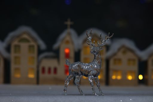 Christmas motif. Crystal deer on a blurred background.