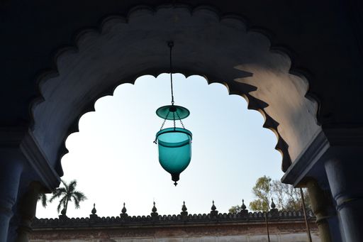 A low angle shot of an unusual lamp hanging by the mosque's entrance in Hugli-Chuchura, India