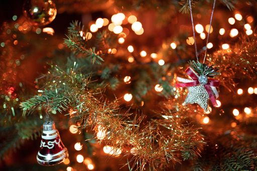 A selective focus shot of ornaments and lights on the decorated Christmas tree