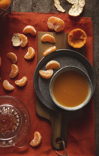 Freshly sliced tangerine with juice on a cutting board