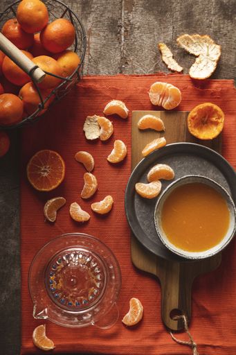 Freshly sliced tangerine with juice on a cutting board