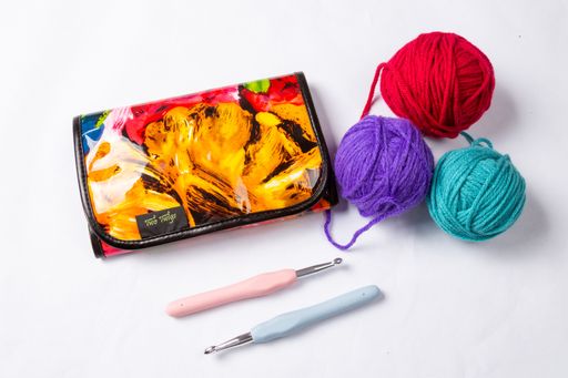 A closeup of crochet hooks and colorful yarn for knitting isolated on a white background