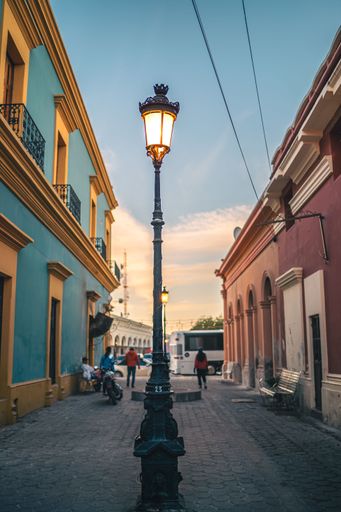 A vertical shot of an illuminated street lantern standing in the streets of El Fuerte city in Mexico against the blue sky