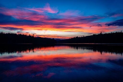 The sun sets after a rainstorm over Turtle Pond in the St. Regis area, near Saranac lake, in the Adirondack Mountains in New York State.