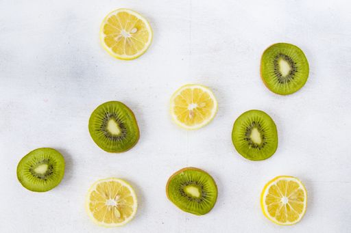 An overhead shot chopped lemon and kiwi on the white background