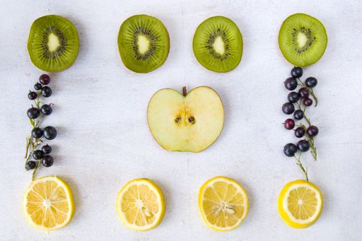 a top view of Currant, Cornus and dogberry, lemon and kiwi on a white background