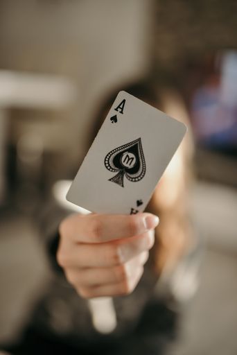 A closeup shot of hands holding playing cards