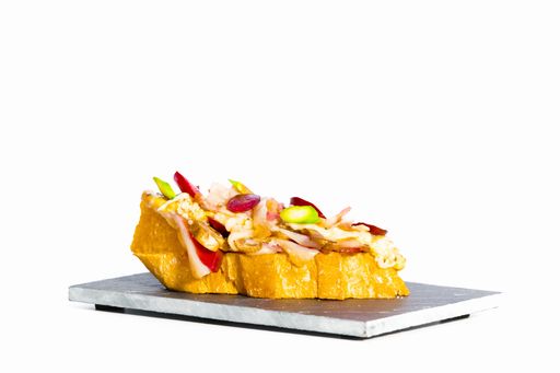 A closeup shot of a delicious sandwich on a black plate isolated on white  background