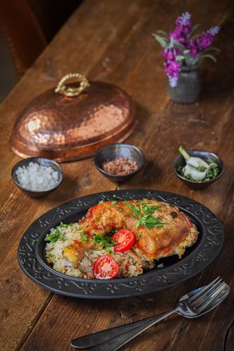 A vertical shot of a delicious restaurant dish of chicken and rice