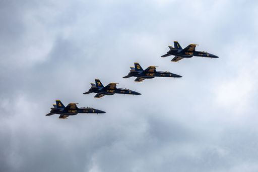 A scenic shot of the Blue Angels performing an air show before the clouds