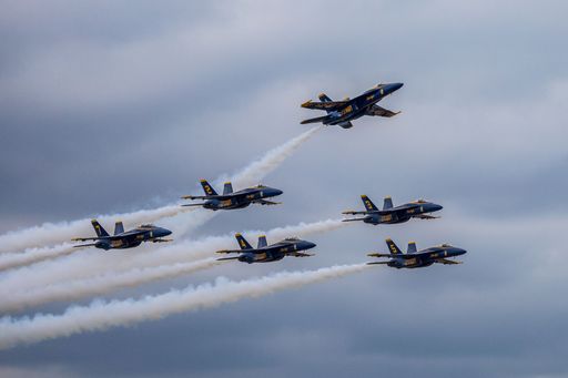 The Blue Angels formation planes flying over Houston against a cloudy sky, United States