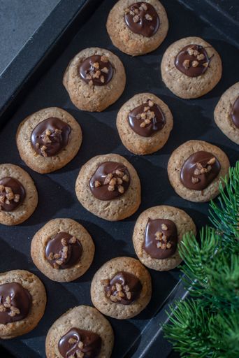 A festive tray of freshly-baked chocolate Christmas cookies with seasonal decorations