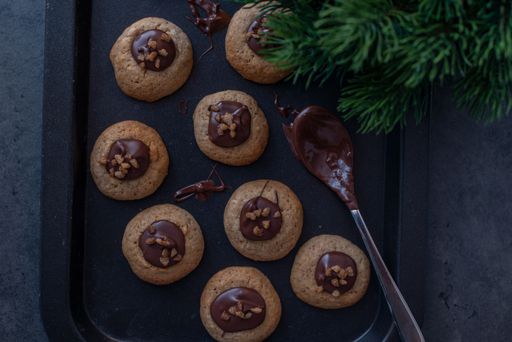 A festive tray of freshly-baked chocolate Christmas cookies with seasonal decorations