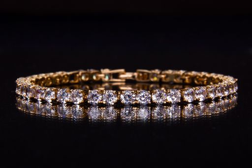 A closeup of bracelet with crystals in black background