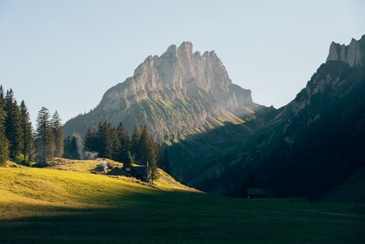 The breathtaking grass-covered meadow by the mountains in Alpstein, Switzerland