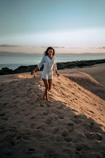 A shallow focus shot of a pretty girl on the beach