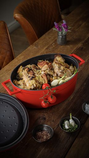 A vertical shot of a pot with a delicious meal of rice and meat