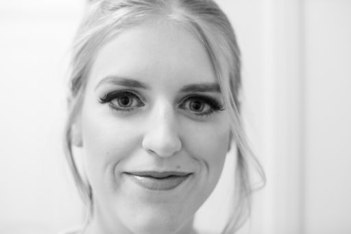 A shallow focus shot of a middle-aged blonde female looking at the camera