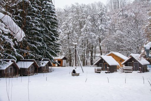 Landscape with wooden cottages in winter