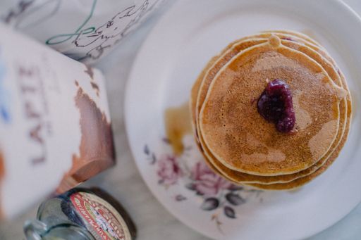 A top view of pancakes on a white plate