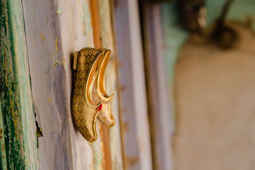 A view of traditional juttis on the wall of an Indian street vendor's stall