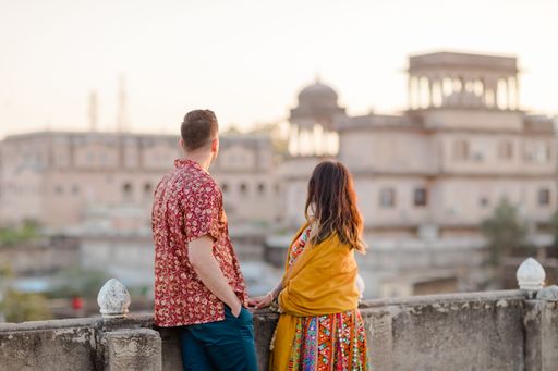 A closeup shot of a cute couple standing in the balcony and admiring the view of Ahar Museum