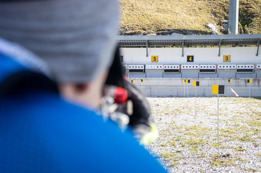 A sportsman playing biathlon and shooting