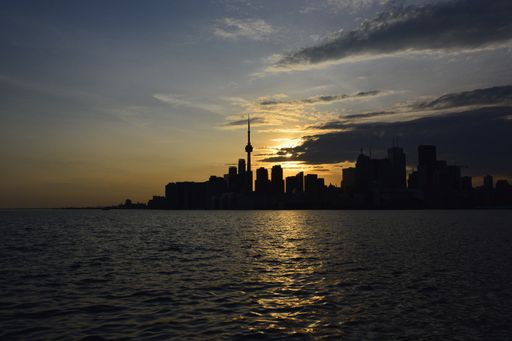 An amazing shot of skyscrapers' silhouettes near the water on a sunset background