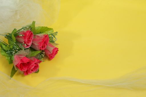 A bouquet of pink roses on a yellow background with space for text - Valentine's day concept