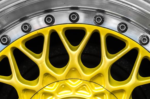 A closeup shot of the yellow metal hub of a car