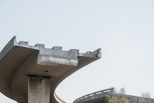 A low angle shot of an unfinished expressway on a cloudy day