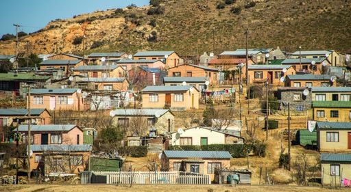 A wide angle shot of several buildings next to each other on a mountain