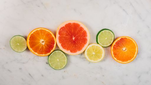 A top view of sliced citrus fruits mix on a white table
