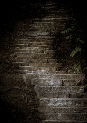 A vertical low angle shot of the stone-made stairs - mystery