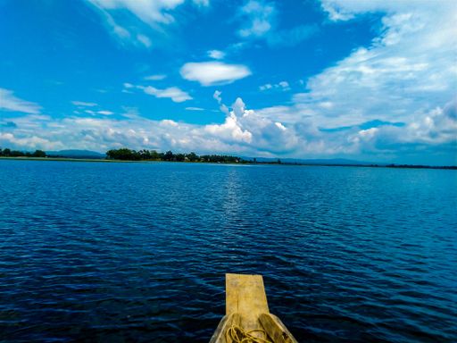 A beautiful shot of the blue river or lake from the boat - bright cloudy sky, sumemrtime