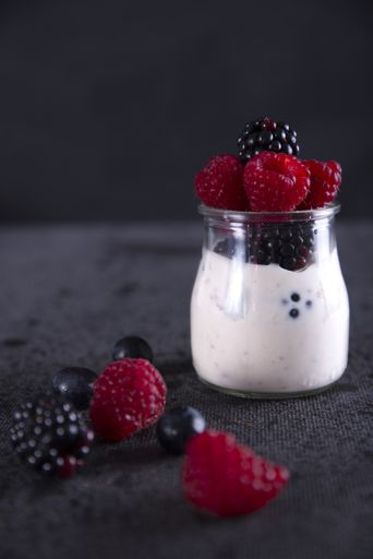 Healthy diet with red fruits such as blackberries, blueberries, raspberries and yogurt.
