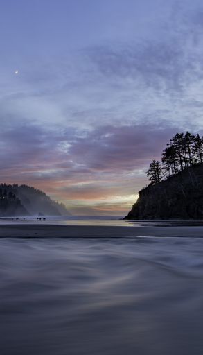 A vertical shot of the Proposal Rock in at sunset in Neskowin Oregon