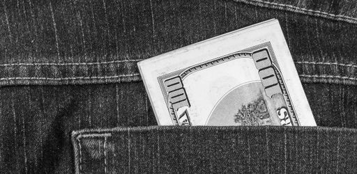 A closeup shot of hundred dollars in the pants pocket