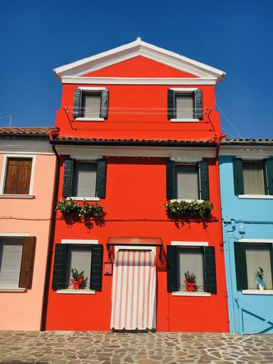 A low angle shot of colorful houses in Burano, Italy