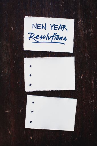 A vertic closeup shot of a piece of paper with new year resolutions written on it
