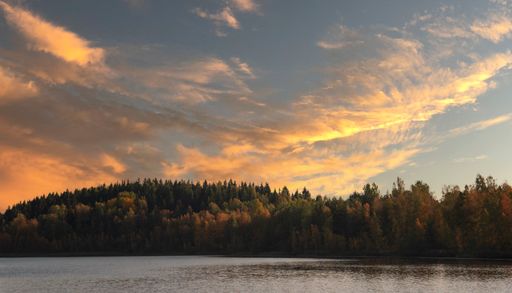 A beautiful shot of a cloudscape over an island at sunset