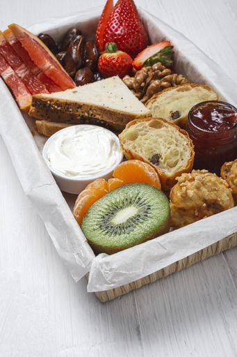 A high angle shot of assorted healthy brunch foods in a box