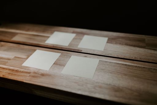 A closeup of sticky note papers attached on a wooden table