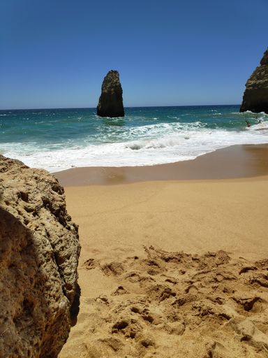 A beautiful view of waves splashing on a sandy beach - perfect for background, wallpaper
