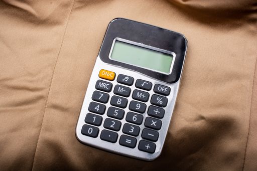 A top view of a calculator on brown cloth