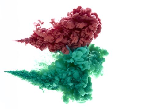 A closeup shot of acrylic color ink in red and green colors isolated on a white background