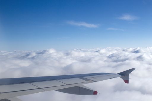 fly over a closed cloud cover with the airplane wing in the picture